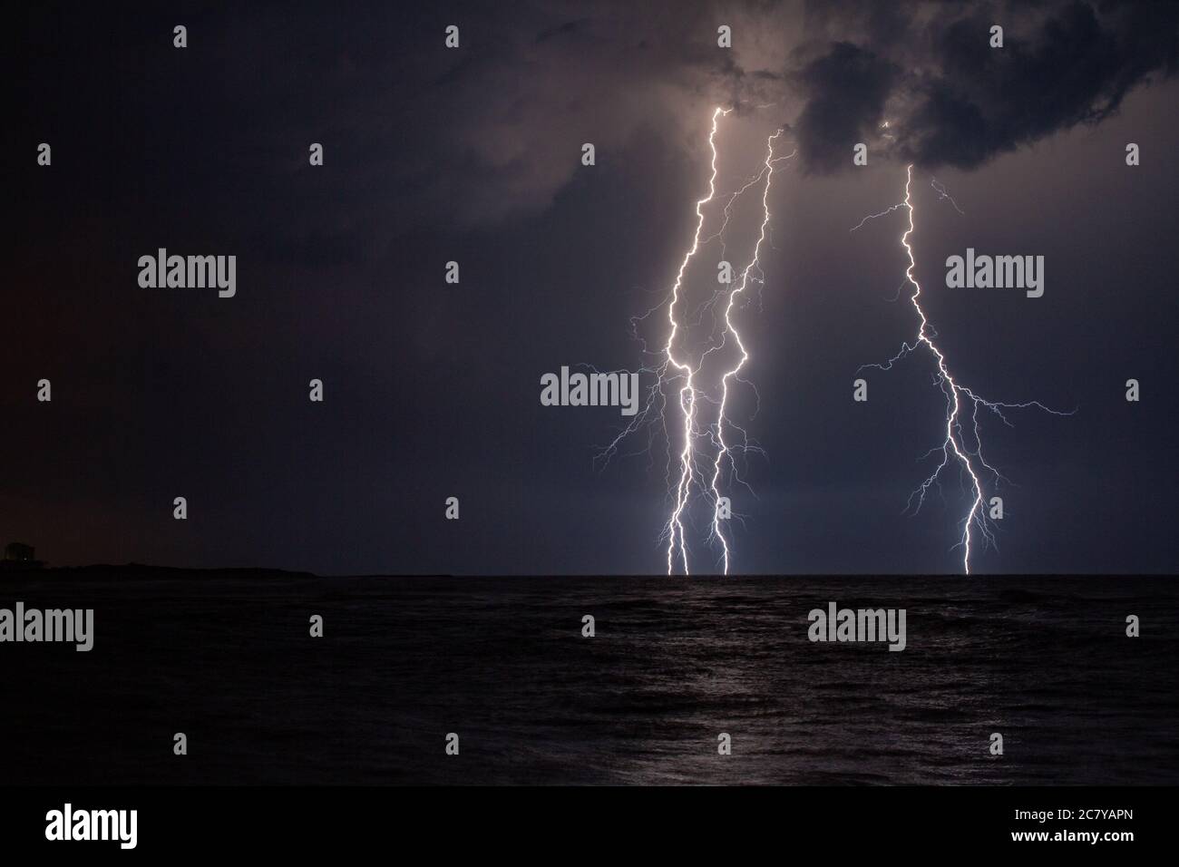 Beautiful scenery of lightning over the stormy sea at night Stock Photo ...