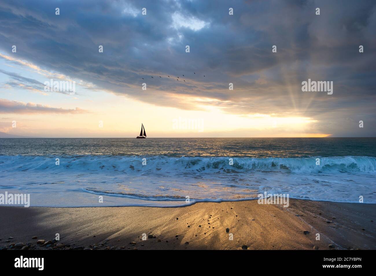A Beautiful Sunset With a Boat Sailing along the Ocean Water As Sun ...