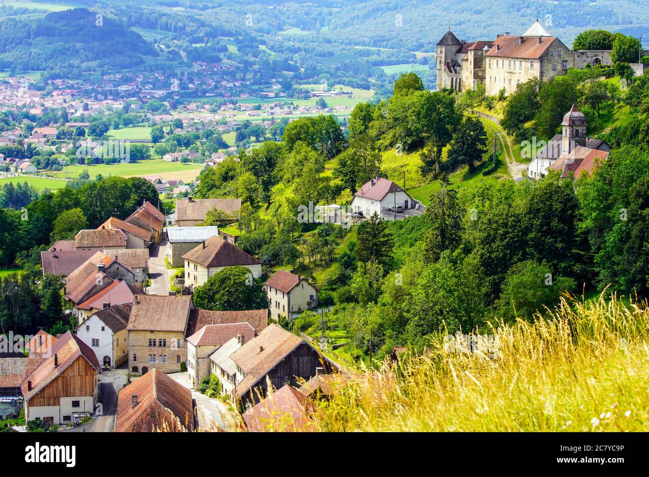 Medieval Chateau (castle) de Belvoir in Doubs department of the Bourgogne-Franche-Comte region in France. Overlooking  Belvoir village  and the valley Stock Photo