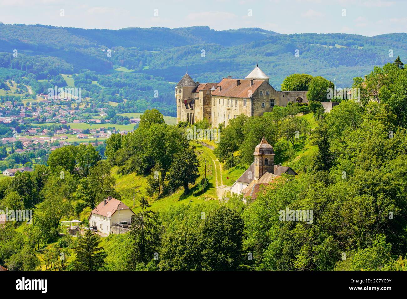 Medieval Chateau (castle) de Belvoir in Doubs department of the Bourgogne-Franche-Comte region in France. Overlooking Belvoir village and the valley Stock Photo
