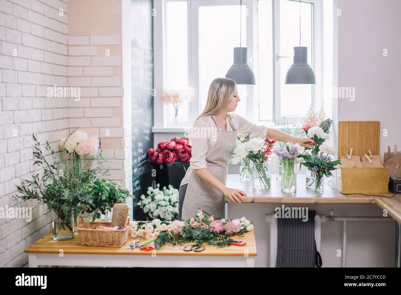 Work Sorting Roses Florist workplace: woman arranging a bouquet with roses, matthiolas ...