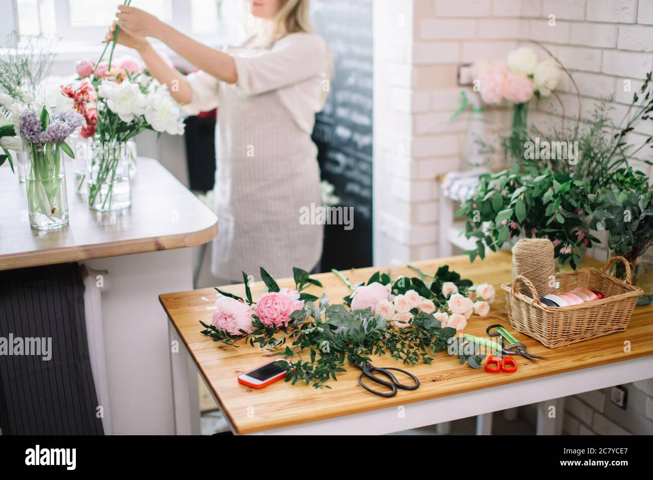 Work Sorting Roses Florist workplace: woman arranging a bouquet with roses, matthiolas ...