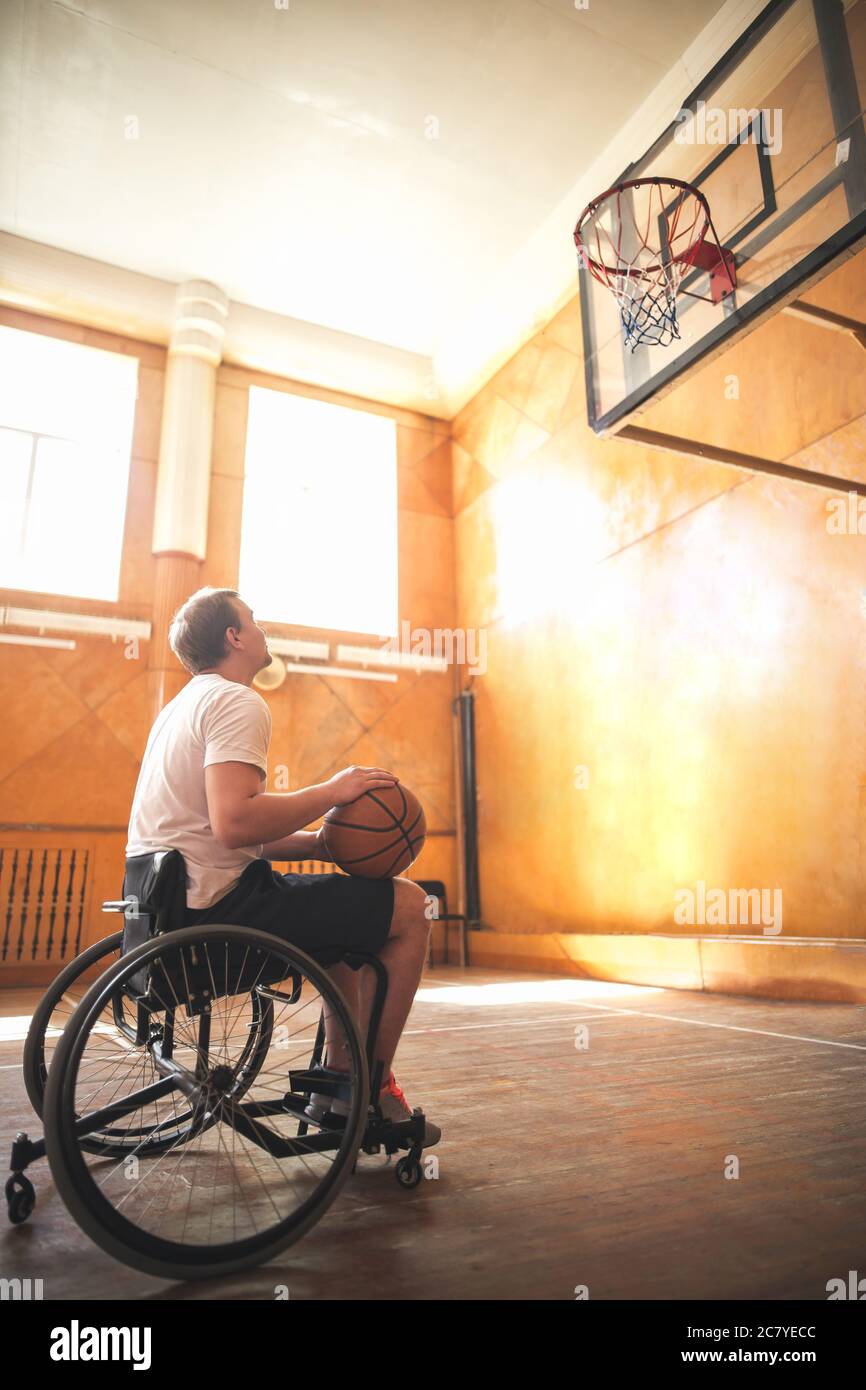 Wheelchair basketball player with ball on his lap Stock Photo Alamy