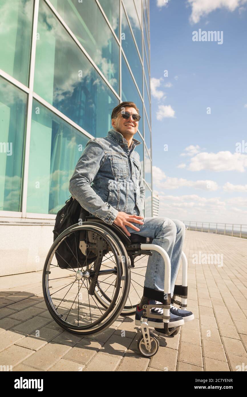 young disabled man in wheelchair walking park Stock Photo Alamy