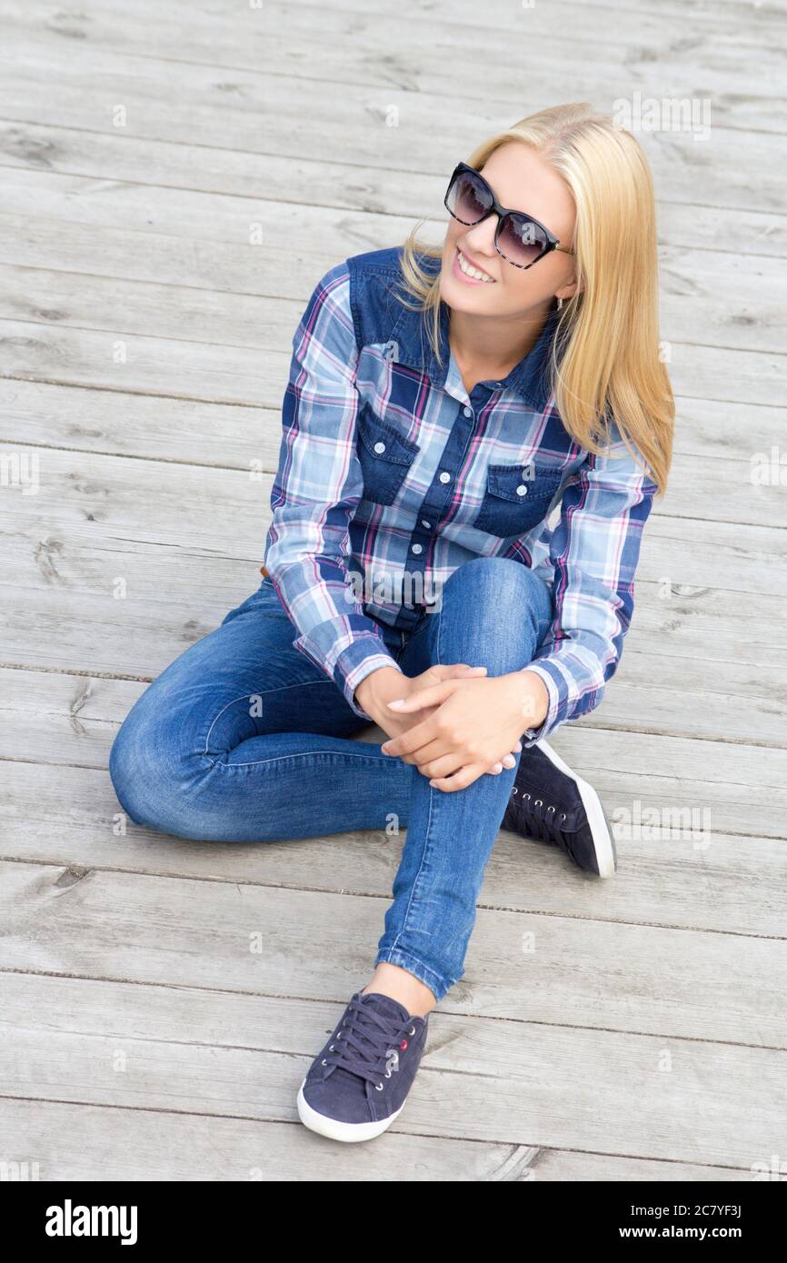 young beautiful teenage girl sitting on wooden floor Stock Photo - Alamy