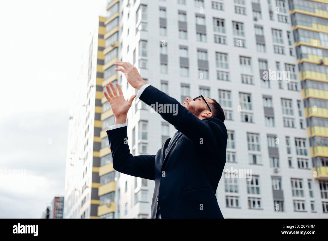 senior builder in hardhats pointing workers outdoors Stock Photo