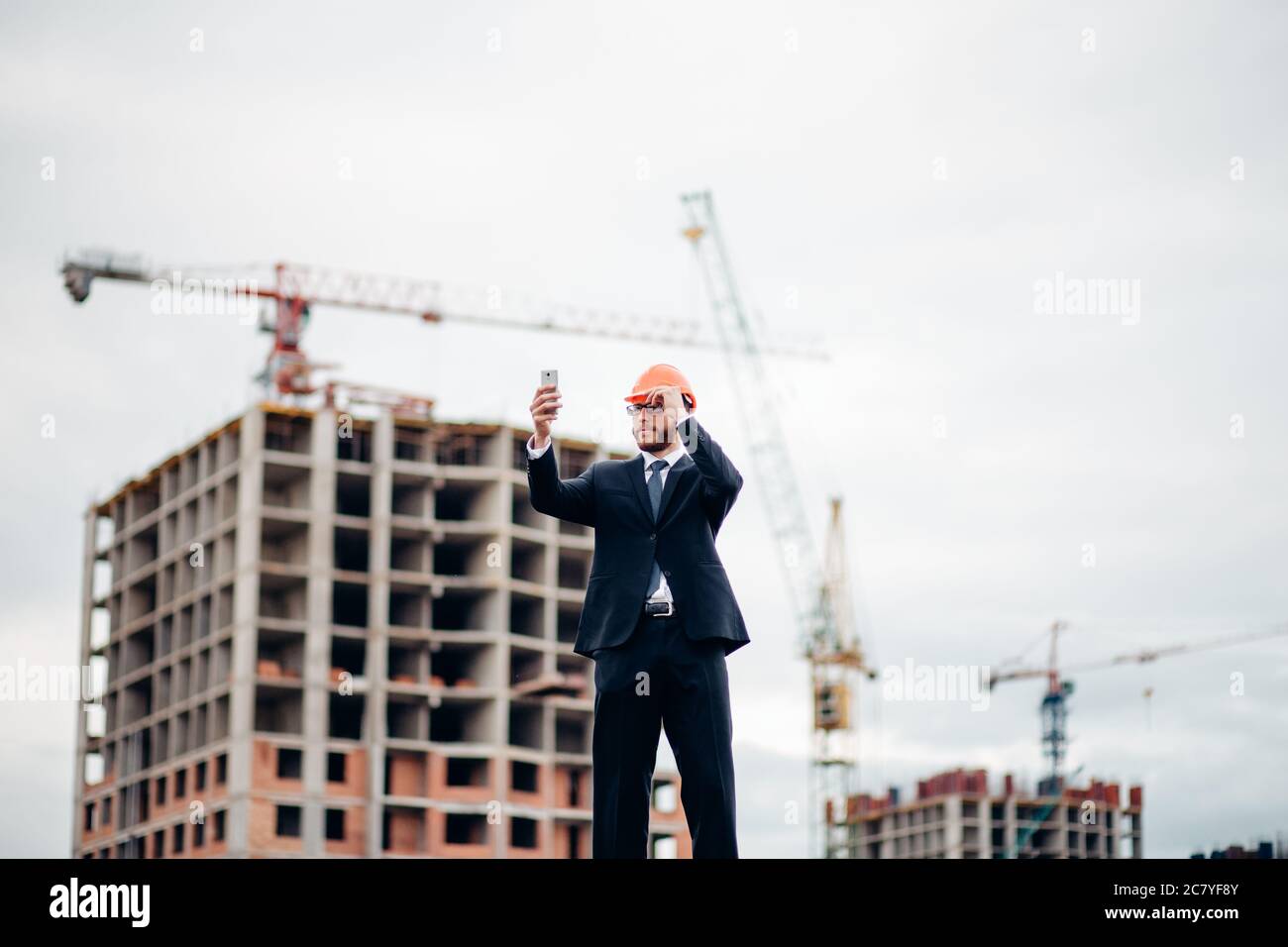 Young engineer makes a selfie at the construction site Stock Photo - Alamy