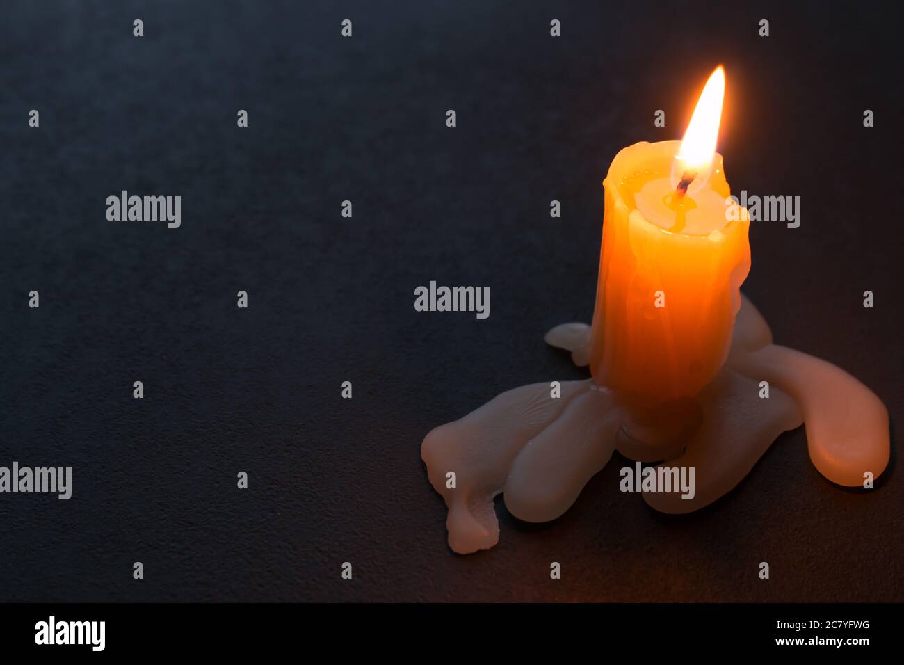 Burning candle and wax on a black background with space for text Stock ...