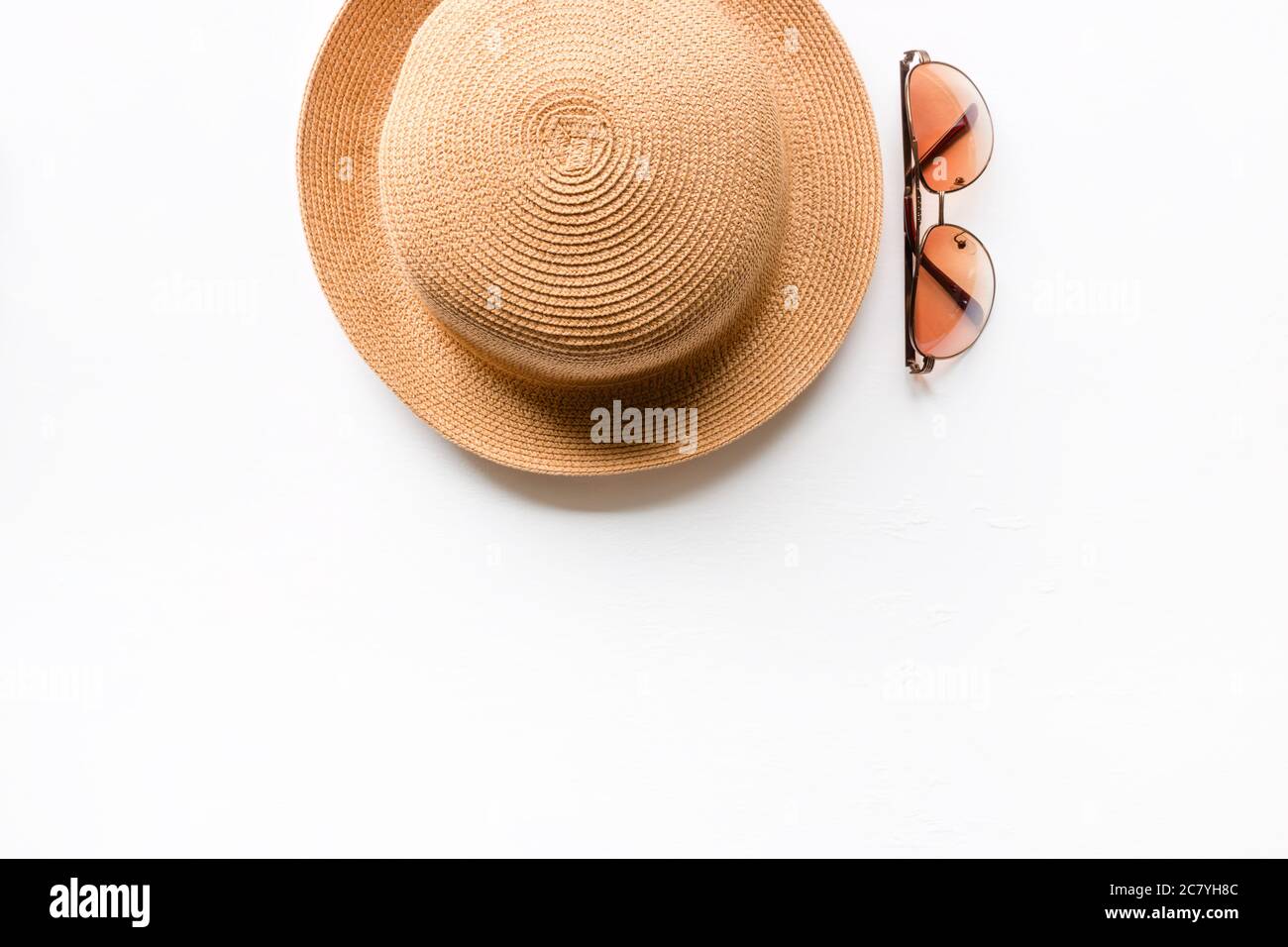 Summer straw hat beach and sunglasses on a white background with place ...