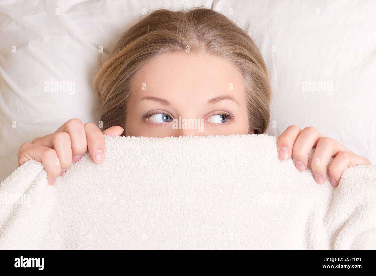Young woman hiding under blanket hi-res stock photography and images - Page  4 - Alamy