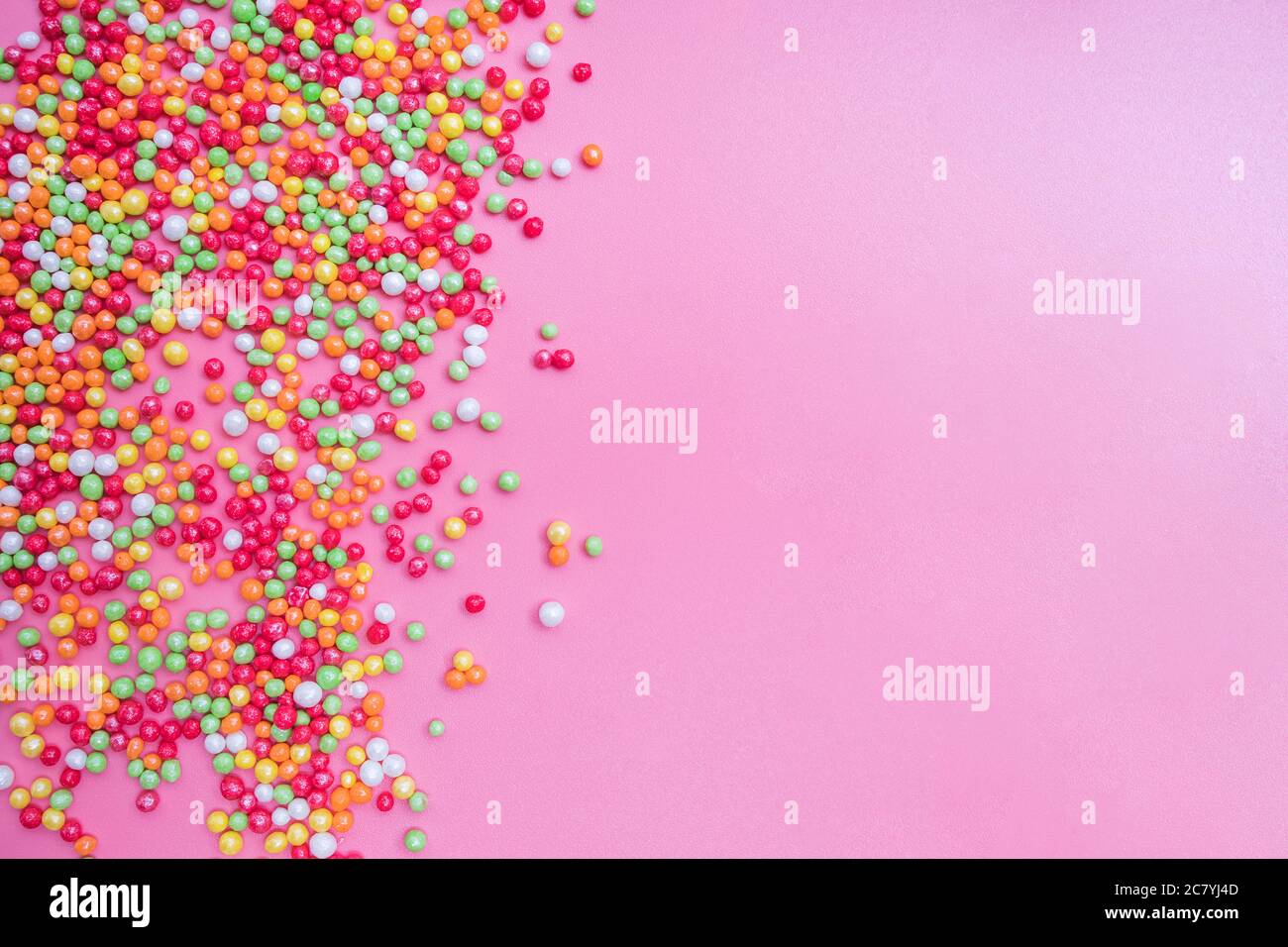 Decorative sugar sprinkles on a pink backdrop Stock Photo - Alamy