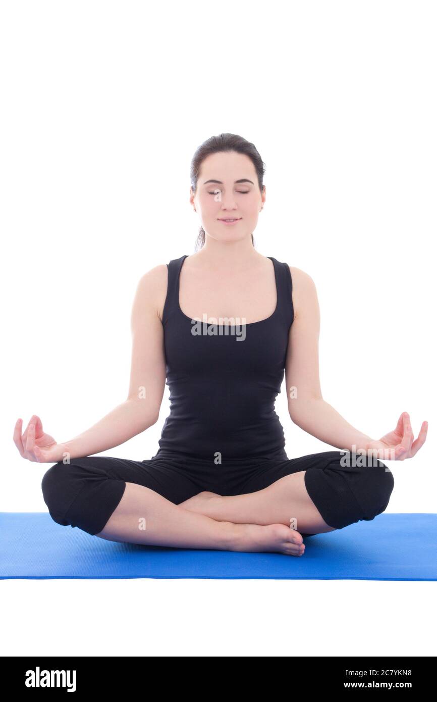 pretty young woman in a meditative yoga pose isolated on white ...