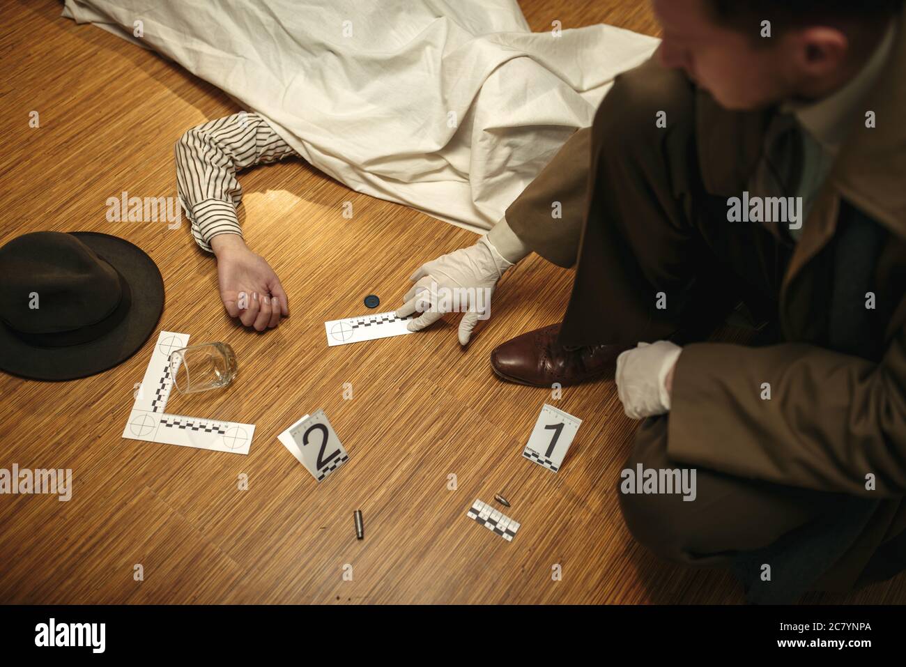 Detective in gloves looking evidence, crime scene Stock Photo Alamy