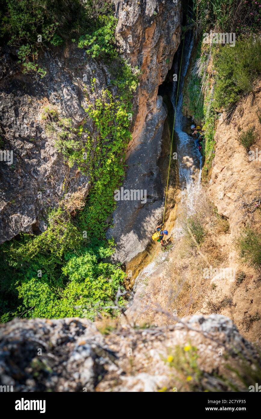 Top view of unrecognizable persons canyoning with ropes Stock Photo