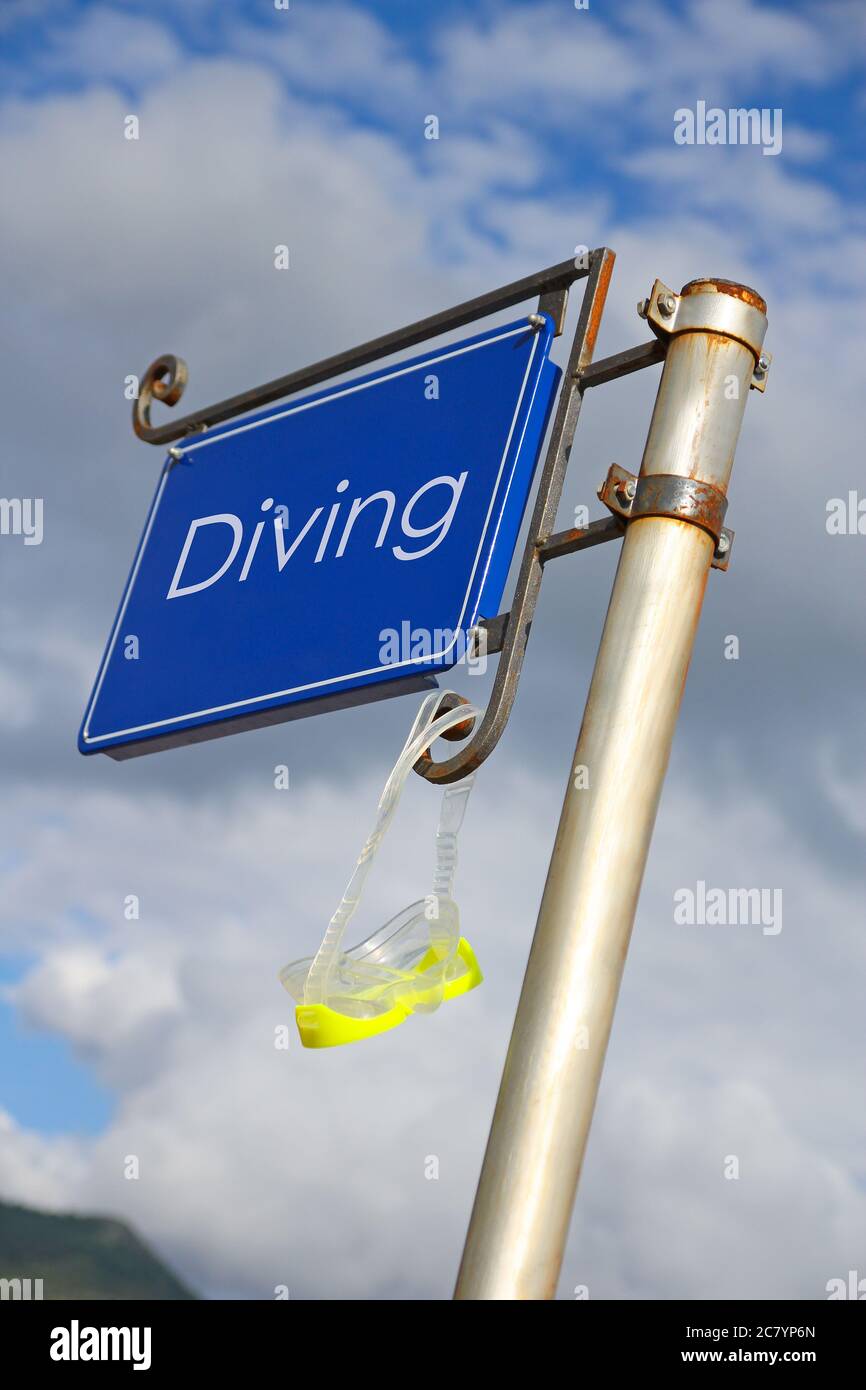 blue metal signboard with diving mask on the beach Stock Photo