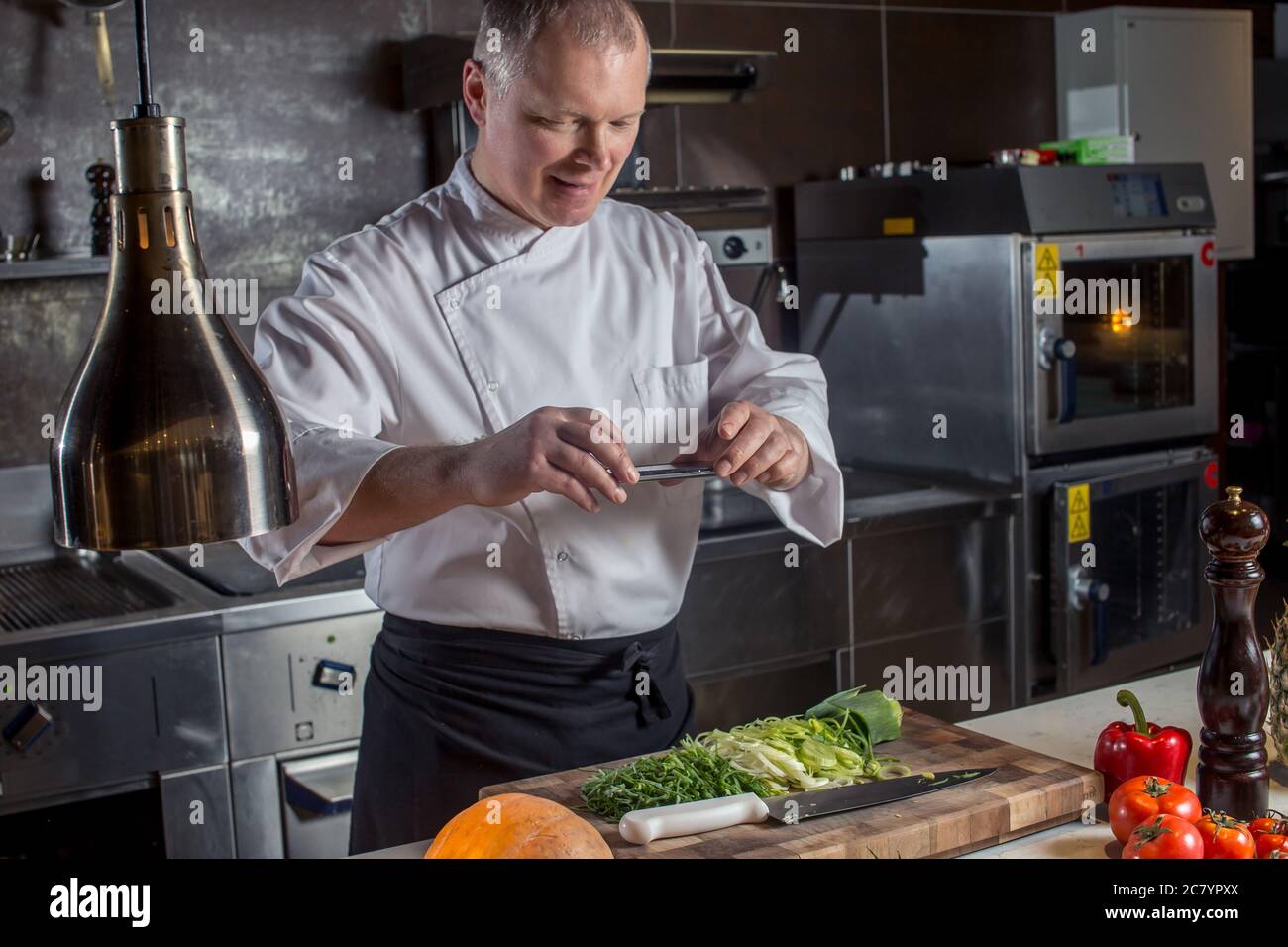 chef shooting with his cell phone camera his cooked food Stock Photo ...