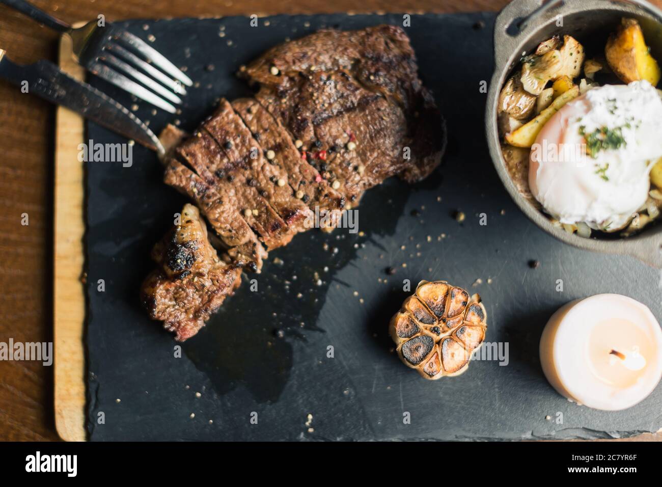 Grilled ribeye beef steak with red wine, herbs and spices Stock Photo ...