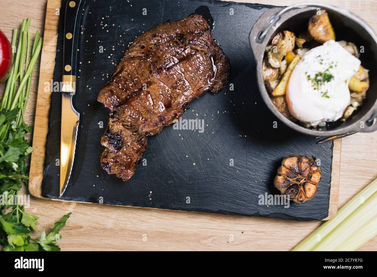 Grilled ribeye beef steak with red wine, herbs and spices Stock Photo ...