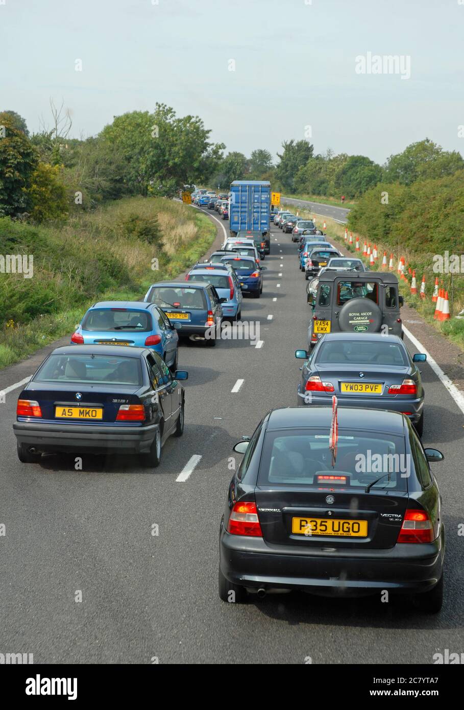 Queue of stationary traffic waiting to join major road at a time when traffic is heavy Stock Photo
