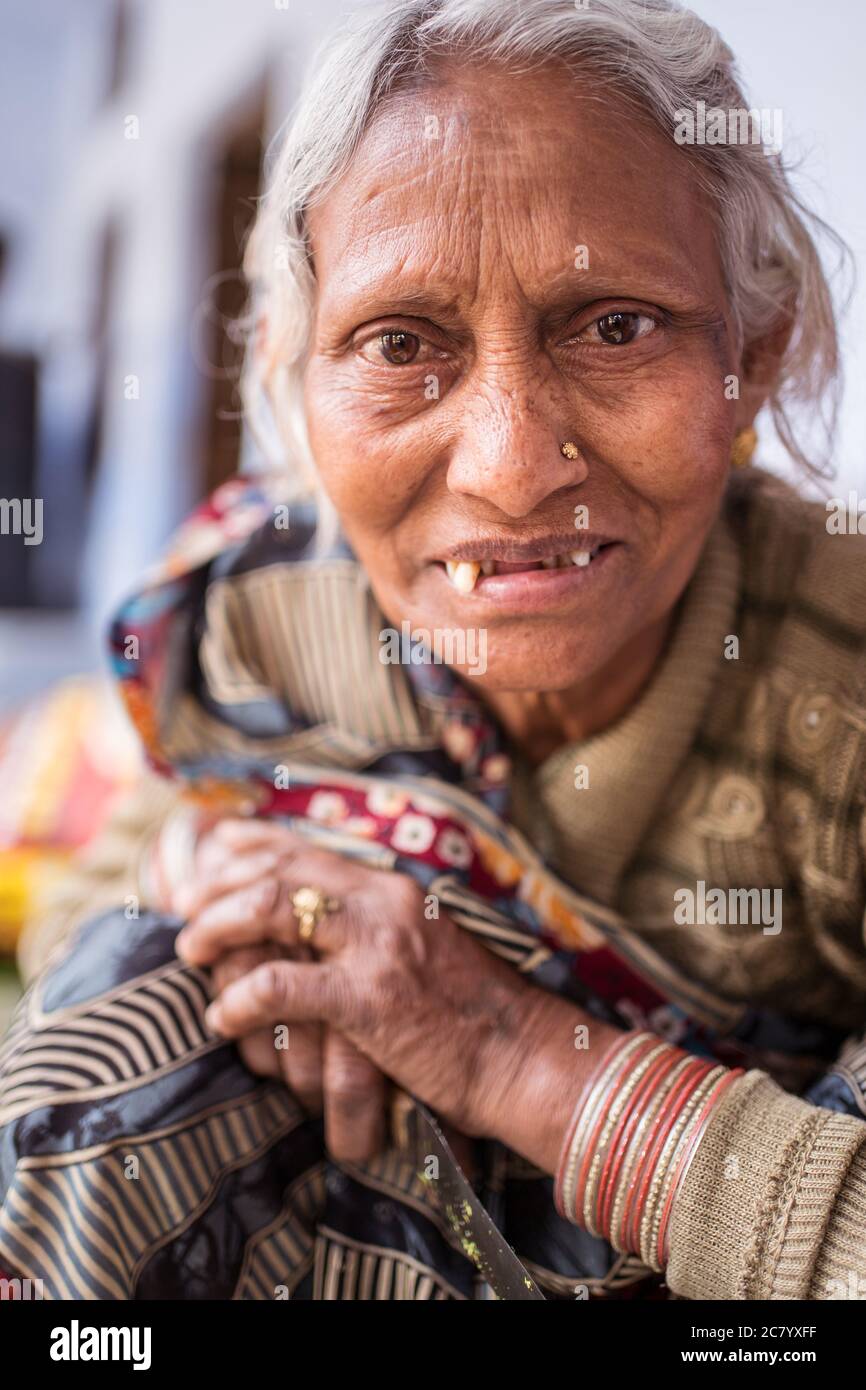 Agra / India - February 13, 2020: portrait of Indian old woman with white hair and head scarf with teeth problems in her mouth Stock Photo