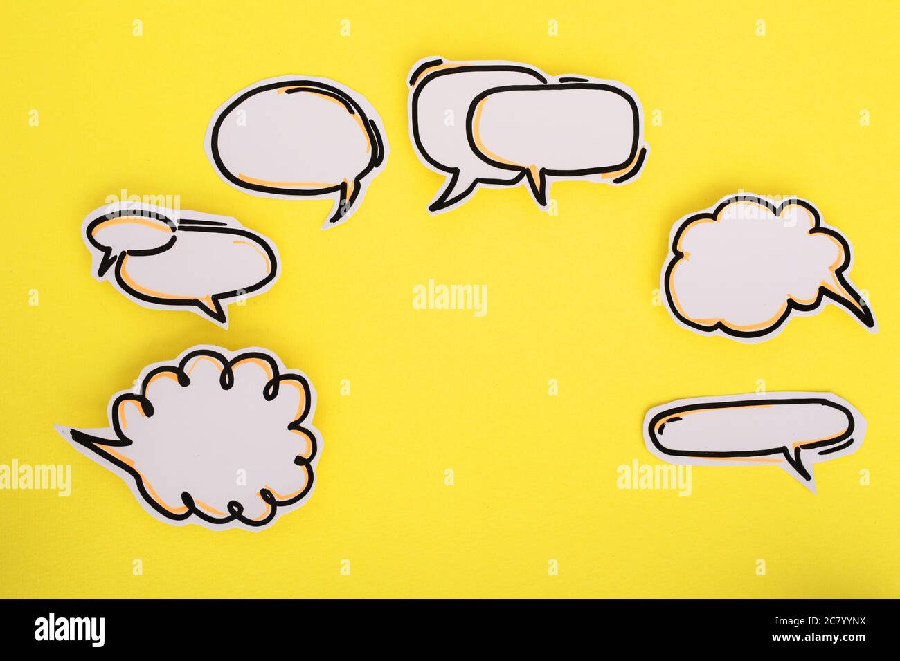 Paper speech bubbles icon on the yellow Stock Photo - Alamy