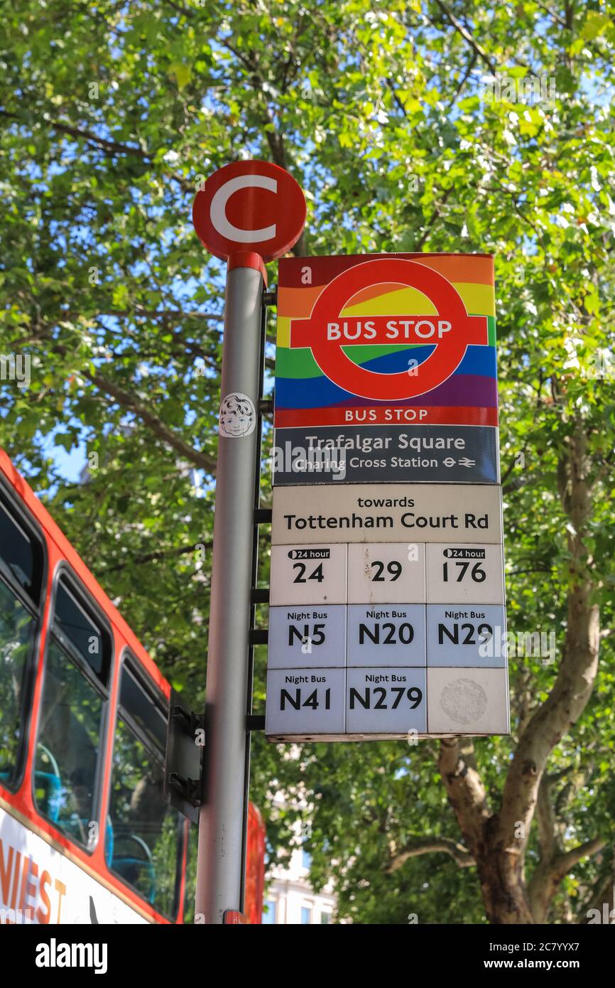 Trafalgar Square bus station stop sign with Pride rainbow decoration,  London, England, UK Stock Photo - Alamy