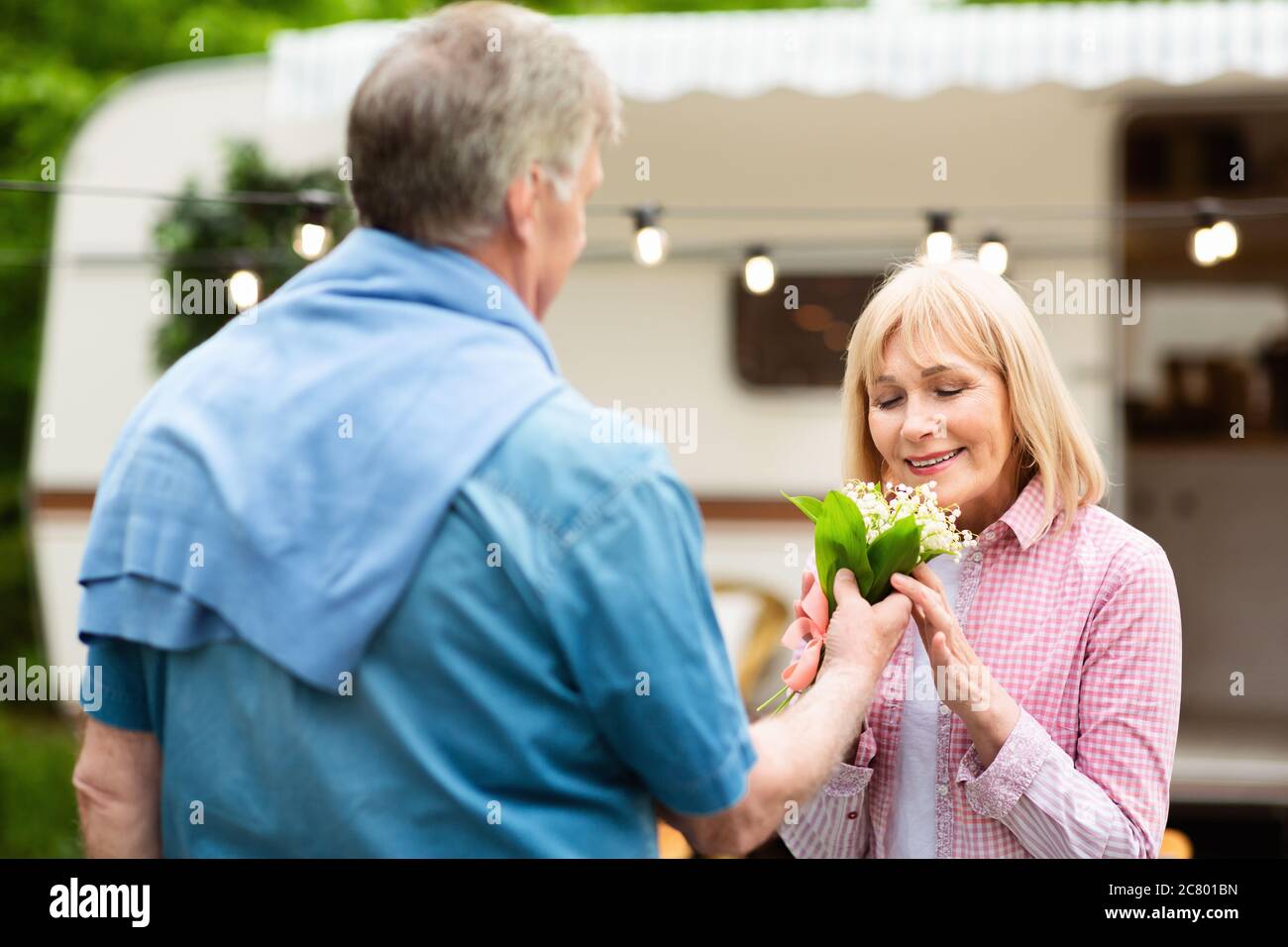 Loving mature husband giving his beloved wife bouquet of aromatic ...