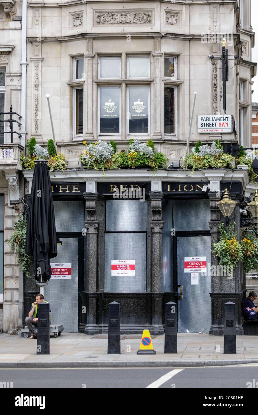 The Red Lion pub, famous drining hole opposite Downing Street in Westminster, closed and boarded up during the Covid 19 Coronavirus crisis, London, En Stock Photo