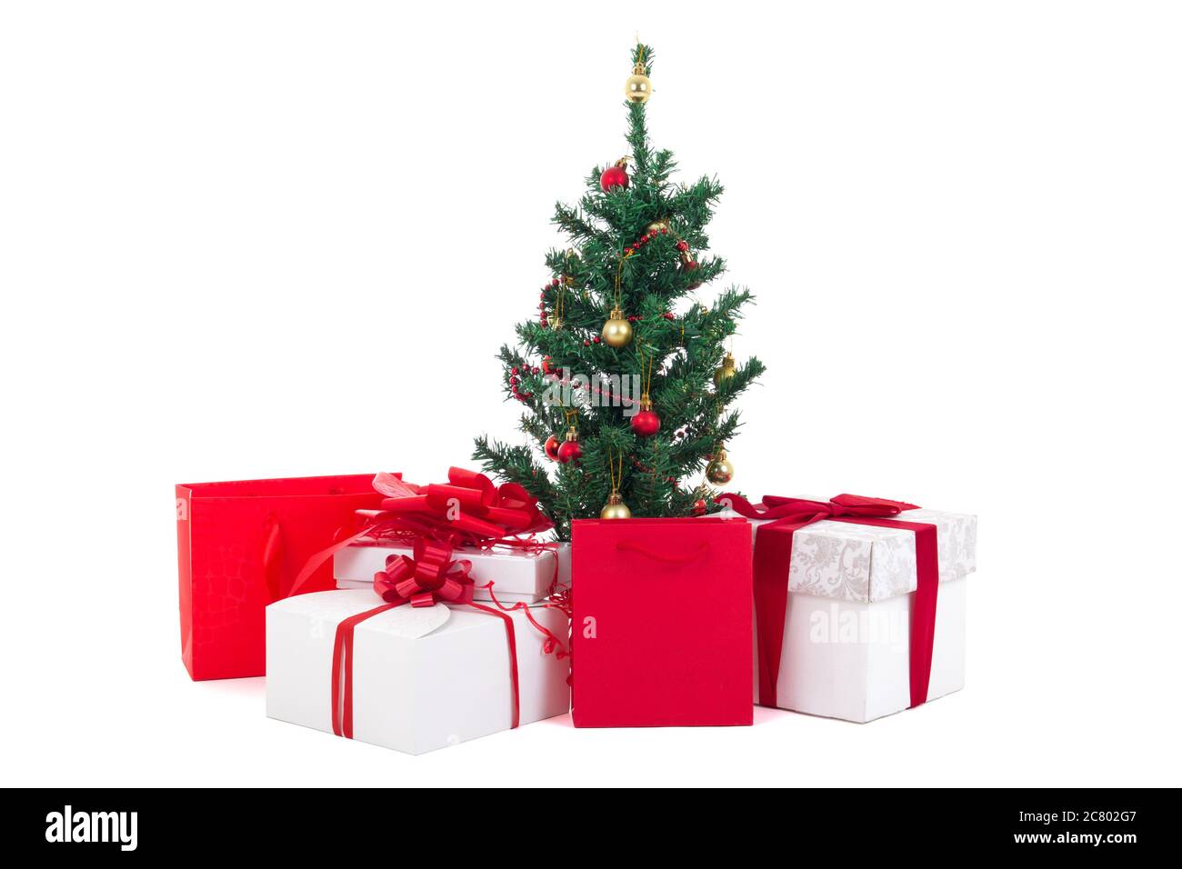 decorated christmas tree and gift boxes isolated on white background ...