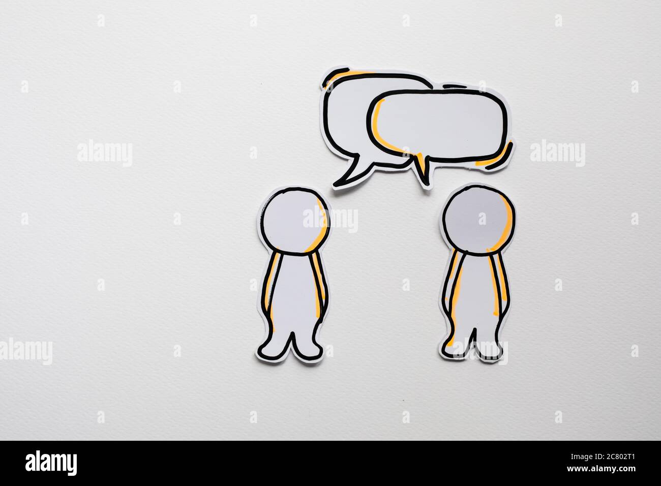 Paper figures with speech bubbles on the white Stock Photo