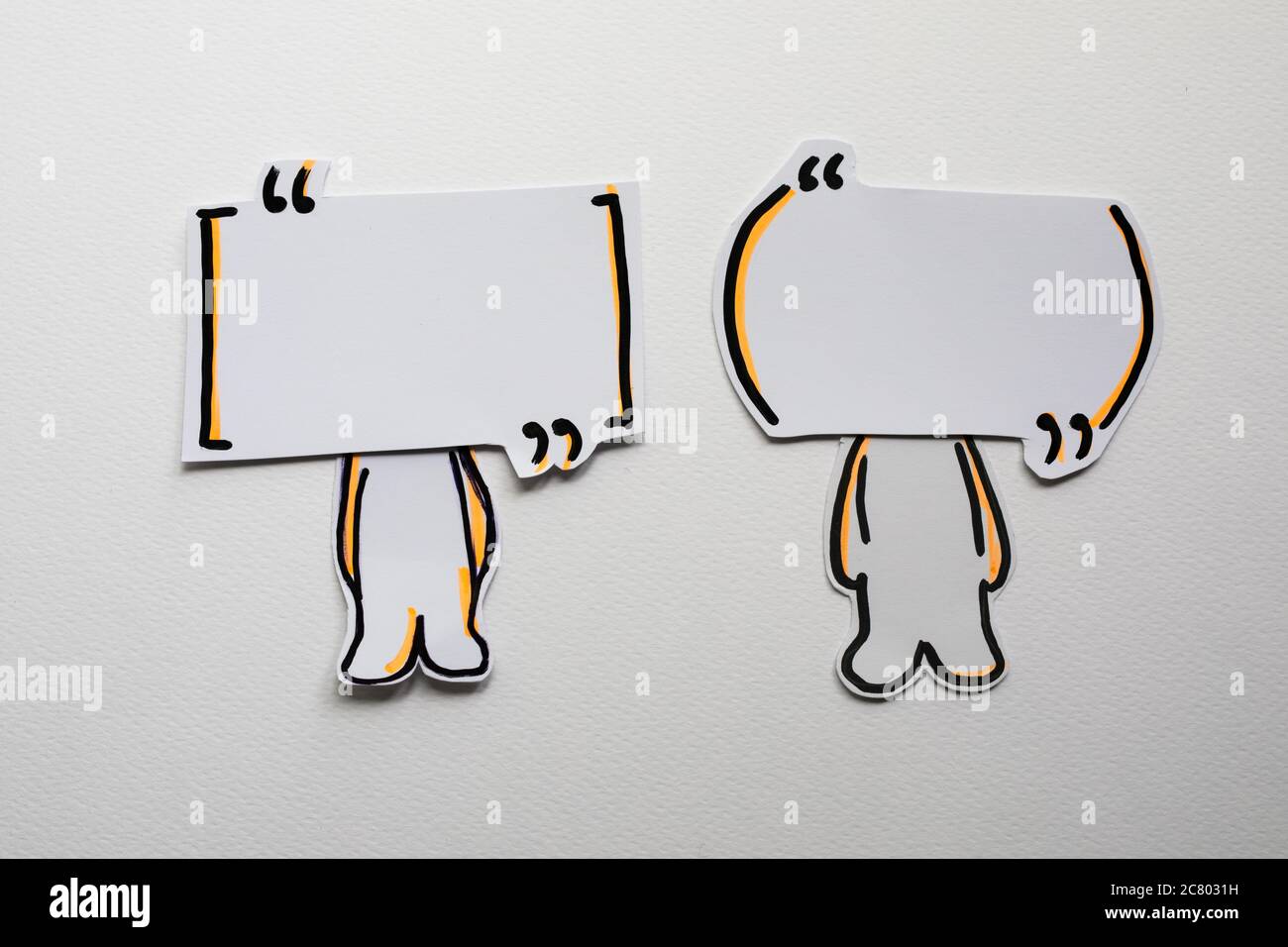 Paper figures with speech bubbles on the white Stock Photo