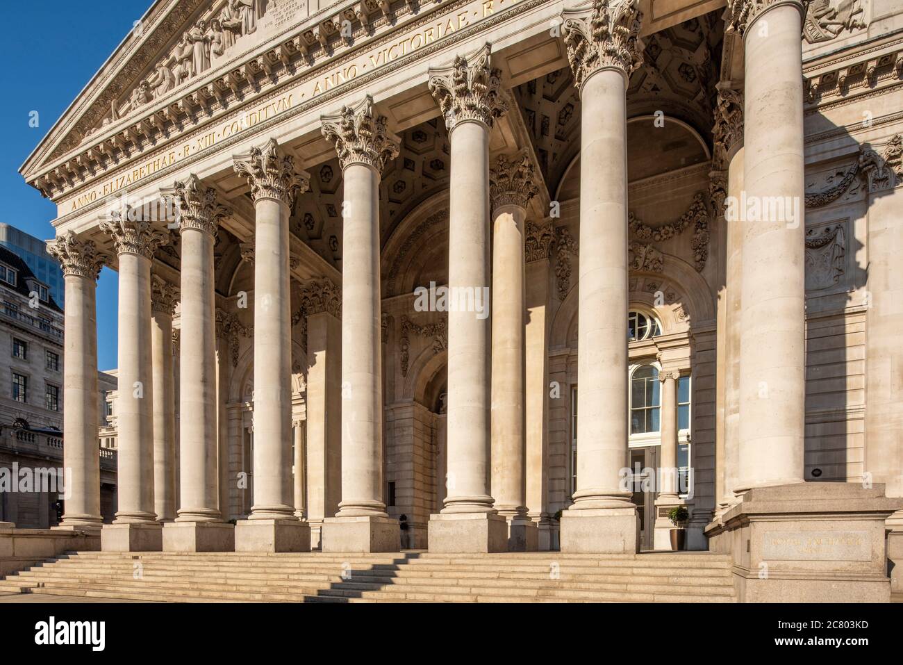 Oblique horizontal view of the portico, the west elevation in golden afternoon sunlight, looking north east. Royal Exchange - The historic ward of Cor Stock Photo