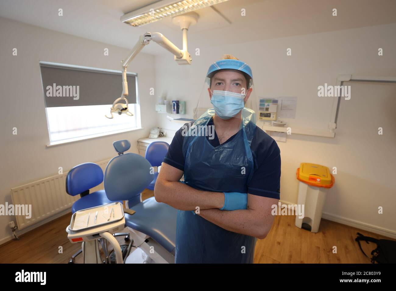 Dentist Dr Allan Clarke wearing PPE at a practice in Belfast Stock