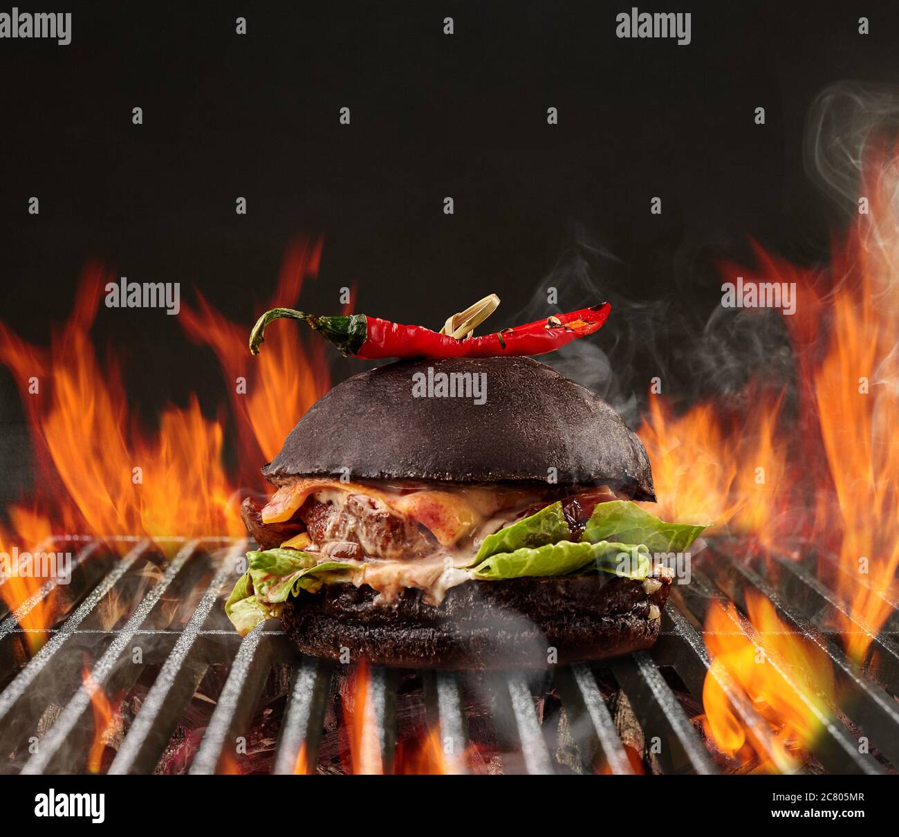 Hamburger with beef, lettuce, cheese and red pepper roasted on metal ...