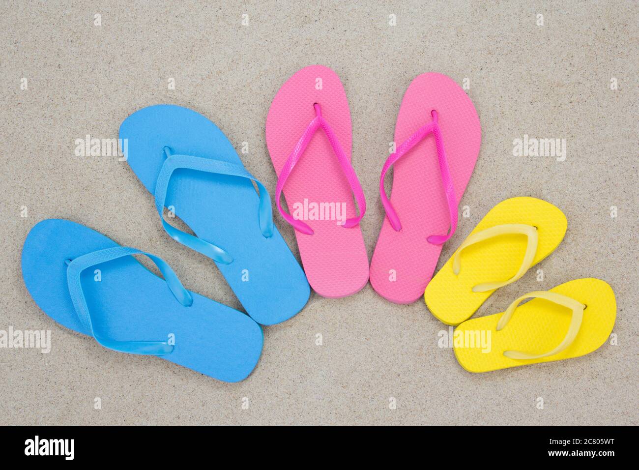 pair of flip flops on white beach sand Stock Photo - Alamy