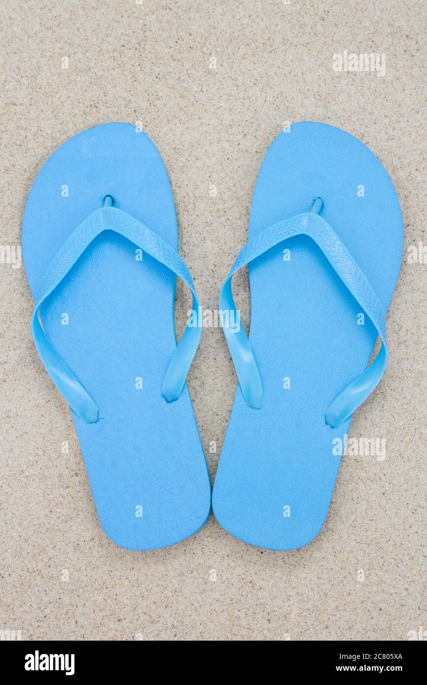 blue flip flops on a sandy beach Stock Photo - Alamy