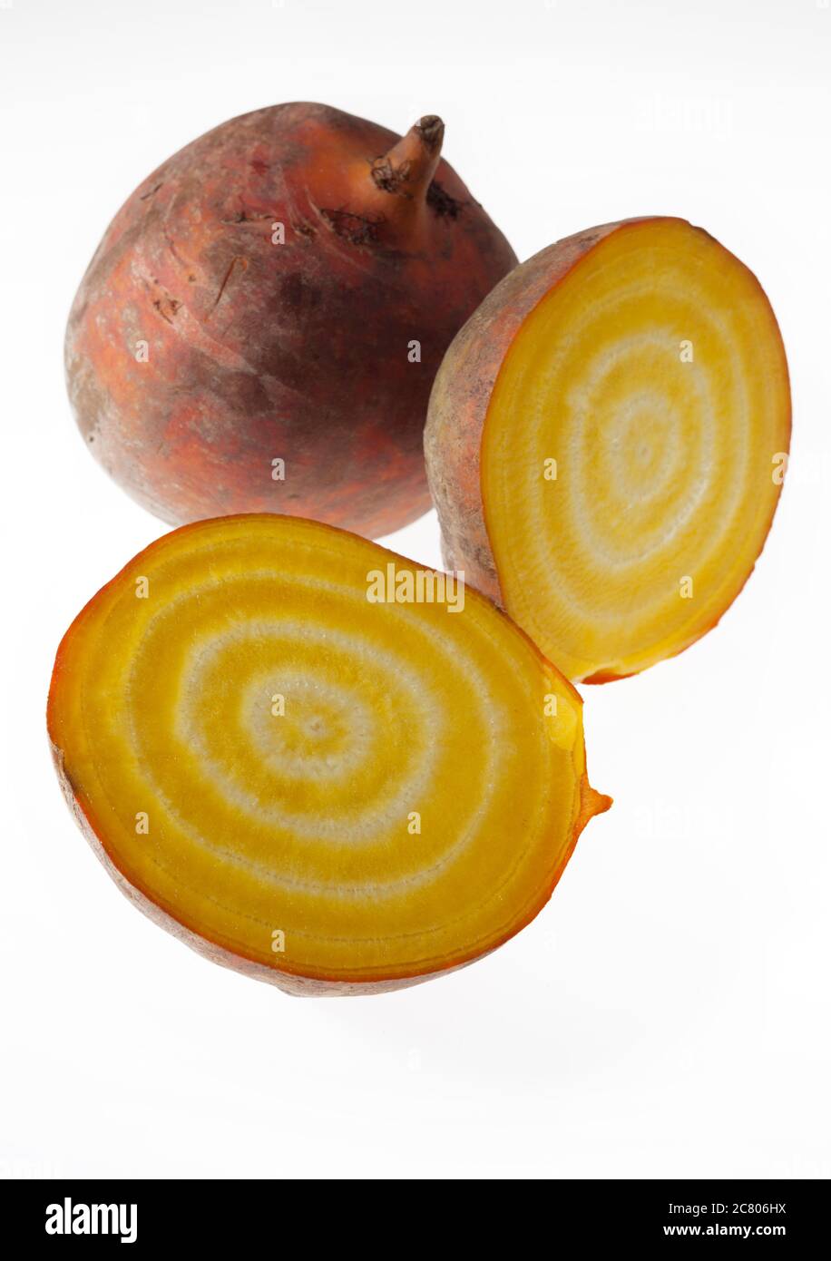 A freshly cut open Golden yellow striped beetroot on a white light box background Stock Photo