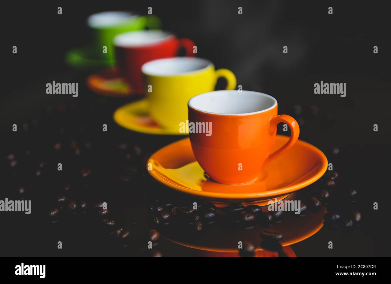 Colorful of espresso coffee cups setting with dark background and coffee bean. Stock Photo