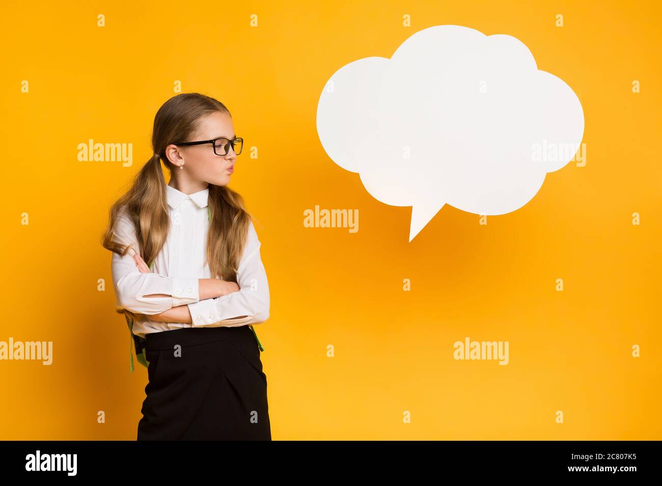 Discontented Schoolgirl Thinking Standing Near Speech Bubble, Mockup, Studio Shot Stock Photo