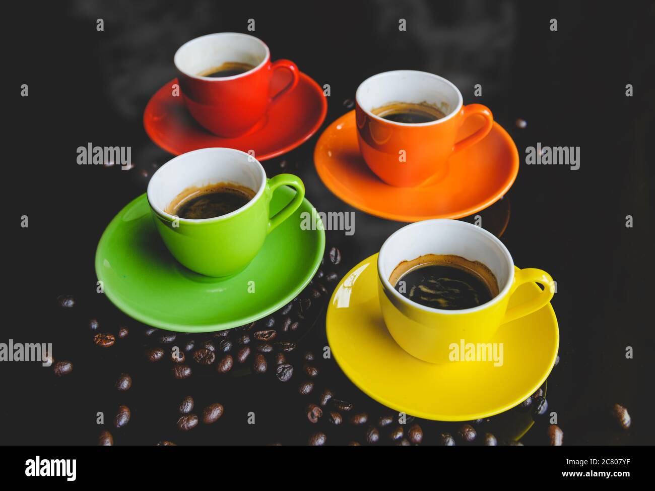 Colorful of espresso coffee cups setting with dark background and coffee bean. Stock Photo