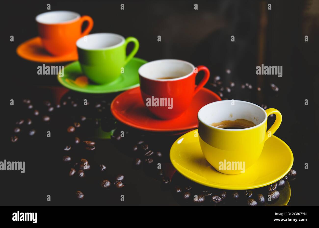 Colorful of espresso coffee cups setting with dark background and coffee bean. Stock Photo