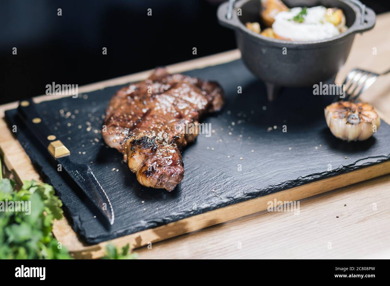 Grilled ribeye beef steak with red wine, herbs and spices Stock Photo ...