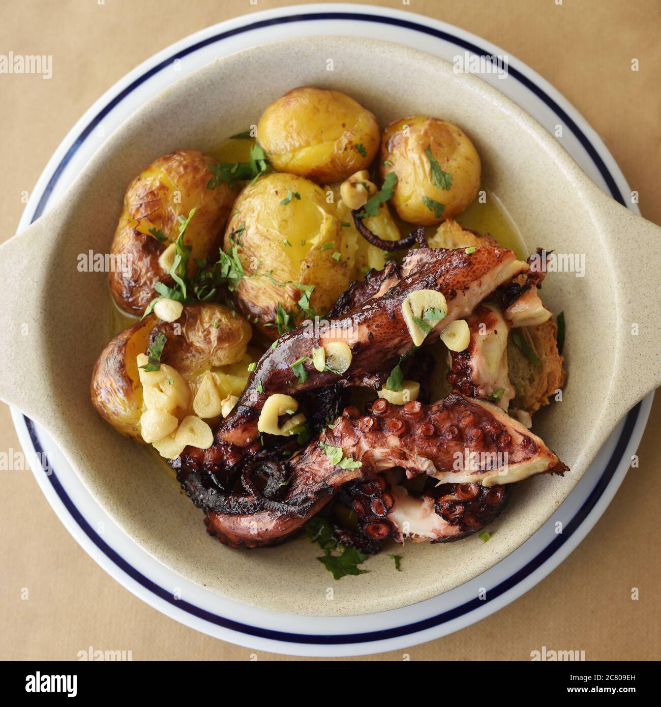 Grilled octopus with batatas a murro, or smashed potatoes and garlic in  olive oil is a traditional Portuguese dishes. View from above Stock Photo -  Alamy