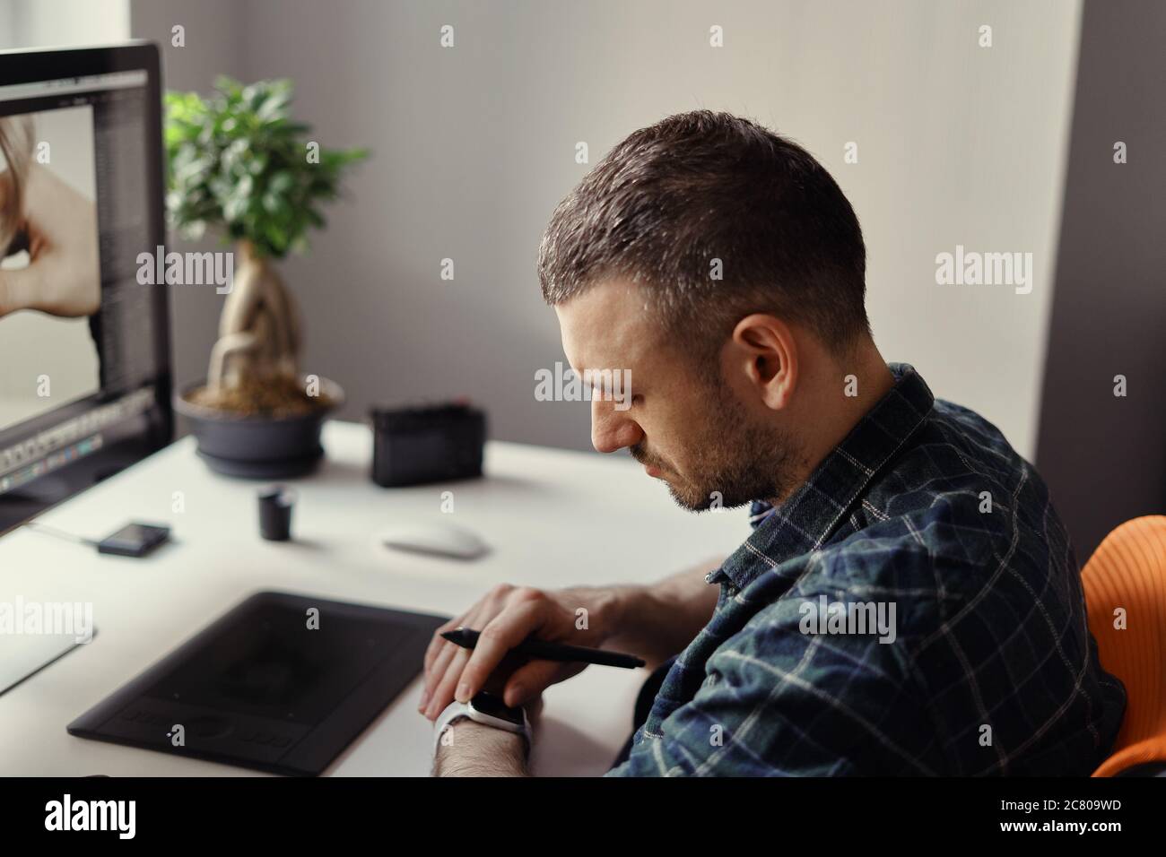 Young man working on his laptop with blank copy space screen for your advertising text message at home. Home office Stock Photo
