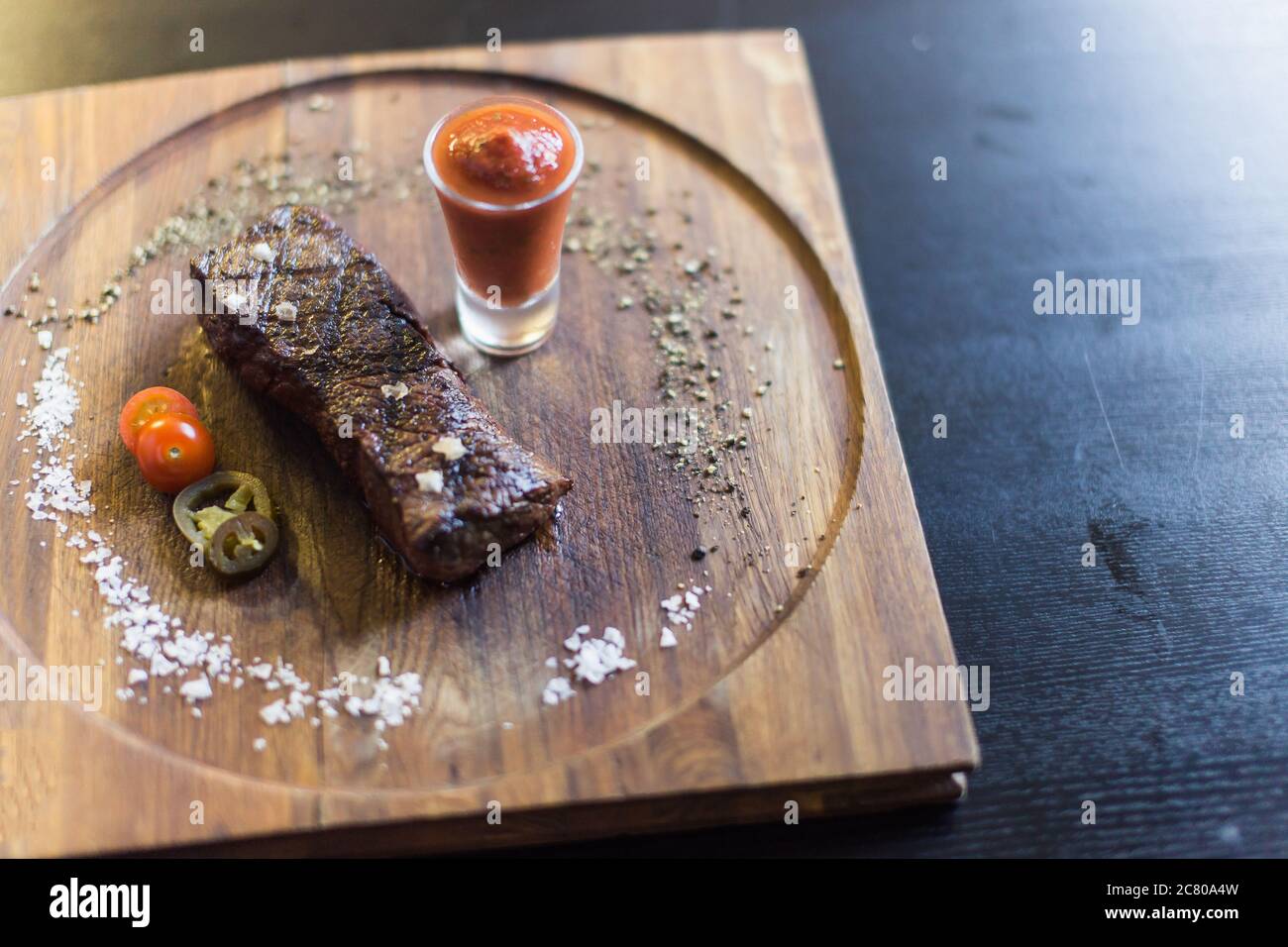 Grilled ribeye beef steak with red wine, herbs and spices Stock Photo ...