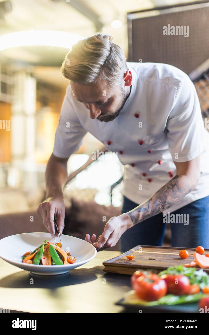 male cooks preparing meat in the restaurant kitchen Stock Photo - Alamy
