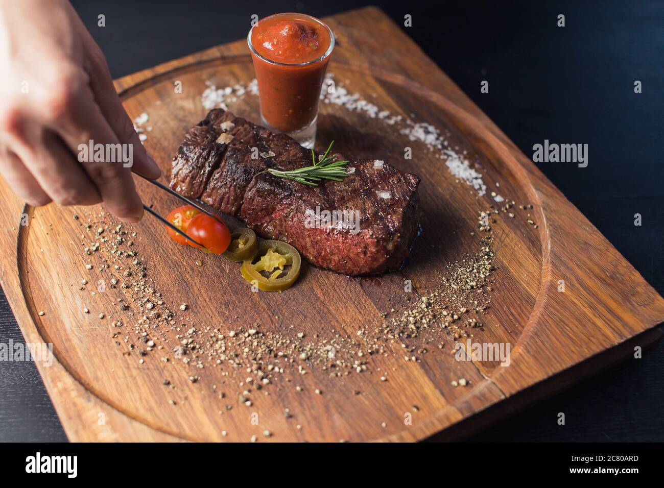 Grilled ribeye beef steak with red wine, herbs and spices Stock Photo ...