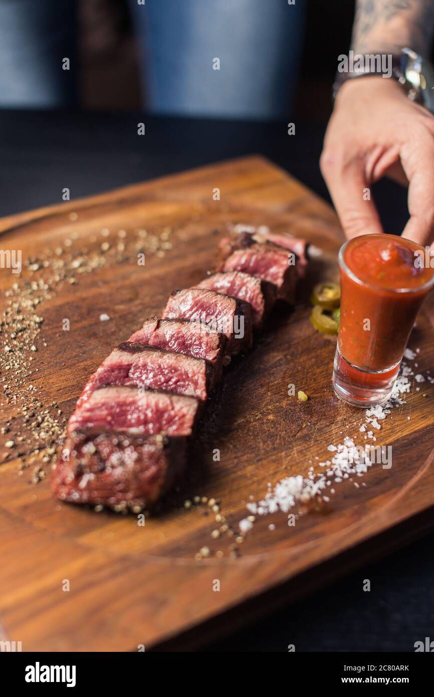 Grilled ribeye beef steak with red wine, herbs and spices Stock Photo ...