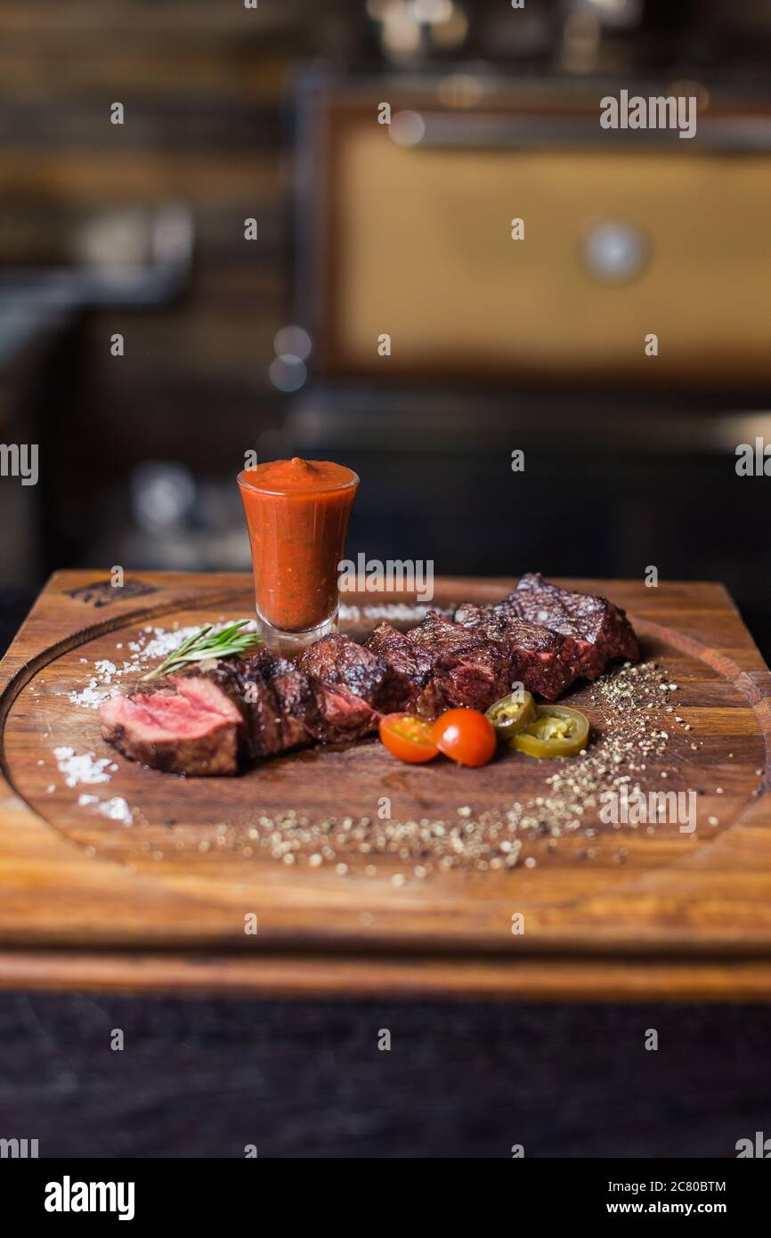 Grilled ribeye beef steak with red wine, herbs and spices Stock Photo ...