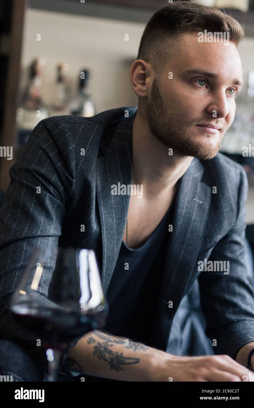 Side view portrait of thinking stylish young man looking away Stock Photo